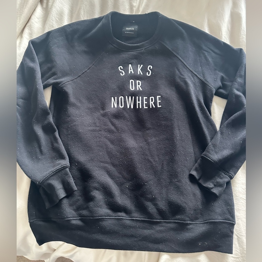 Nolita X Saks black sweatshirt.